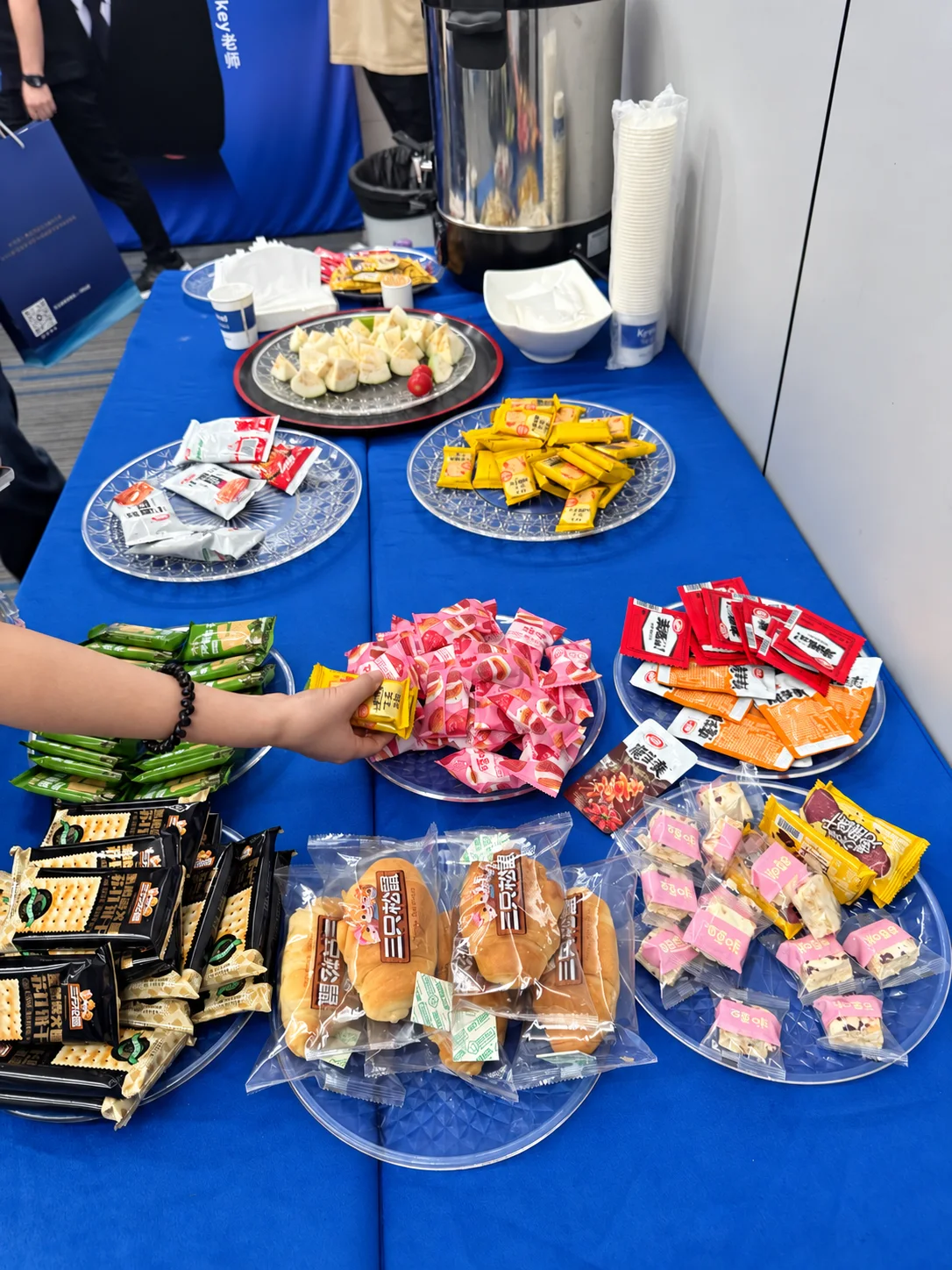 Fruit, biscuits and snacks on a blue-covered table during afternoon tea at Xunding