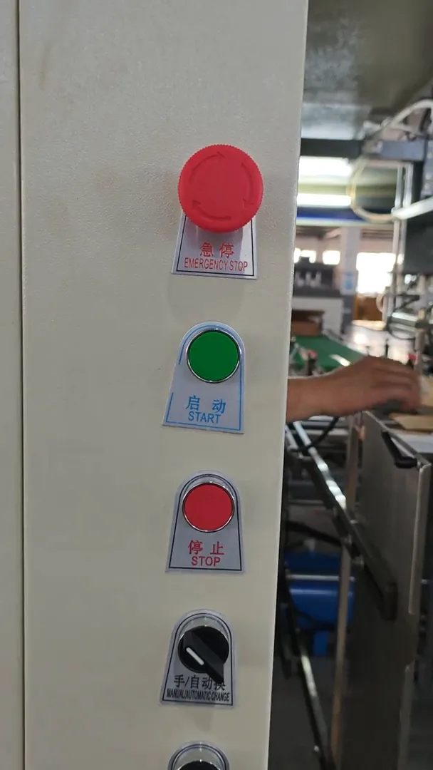 Red mushroom-head emergency stop above the green START and red STOP buttons on the machine operator panel